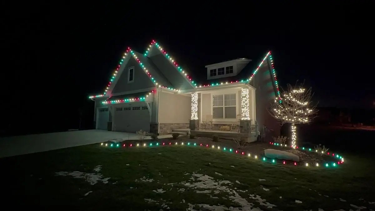 Installing Christmas lights on a home in Cherry Hill New Jersey by Thomas and Son LLC